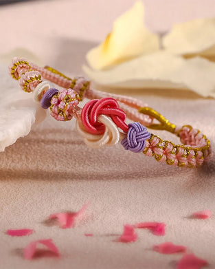 Armband met knoop van perzikbloesems