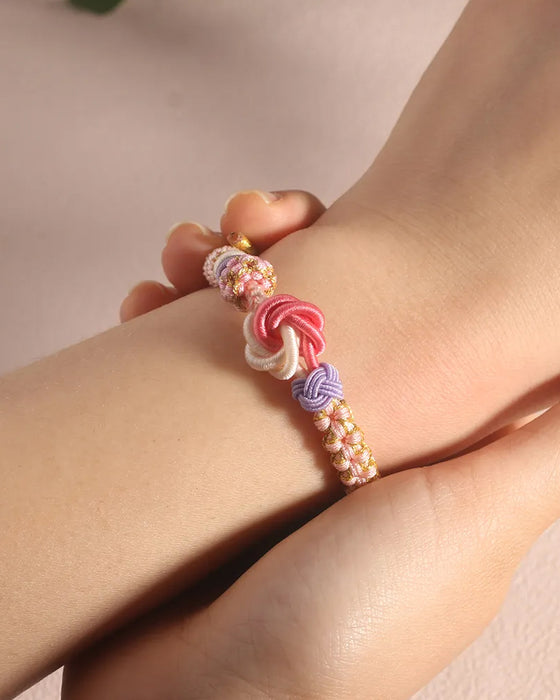 Armband met knoop van perzikbloesems