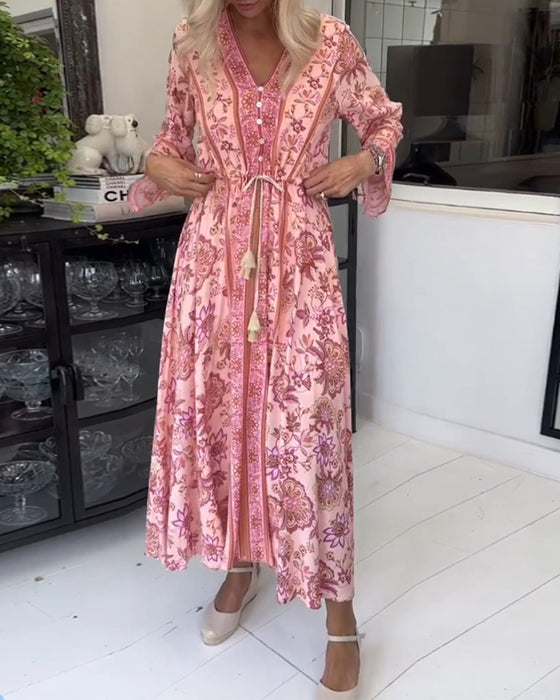 Elegante jurk met V-hals, knoopsluiting en trekkoord met print