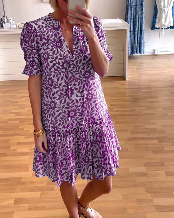 Geplooide jurk met bloemenprint en pofmouwen