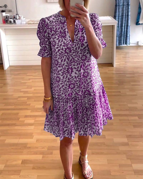 Geplooide jurk met bloemenprint en pofmouwen