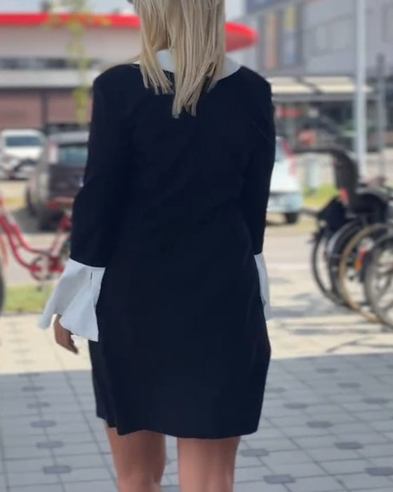 Elegante contrasterende jurk met revers en klokmouw