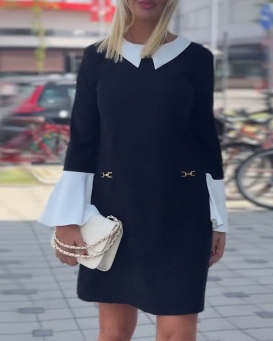 Elegante contrasterende jurk met revers en klokmouw
