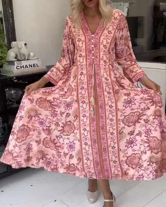 Elegante jurk met V-hals, knoopsluiting en trekkoord met print