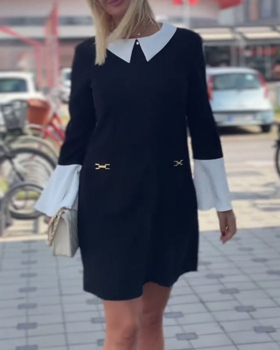 Elegante contrasterende jurk met revers en klokmouw