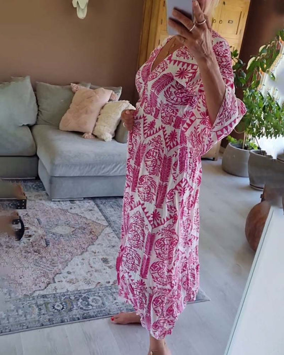 Elegante jurk met geplooide klokmouwen en V-hals met print