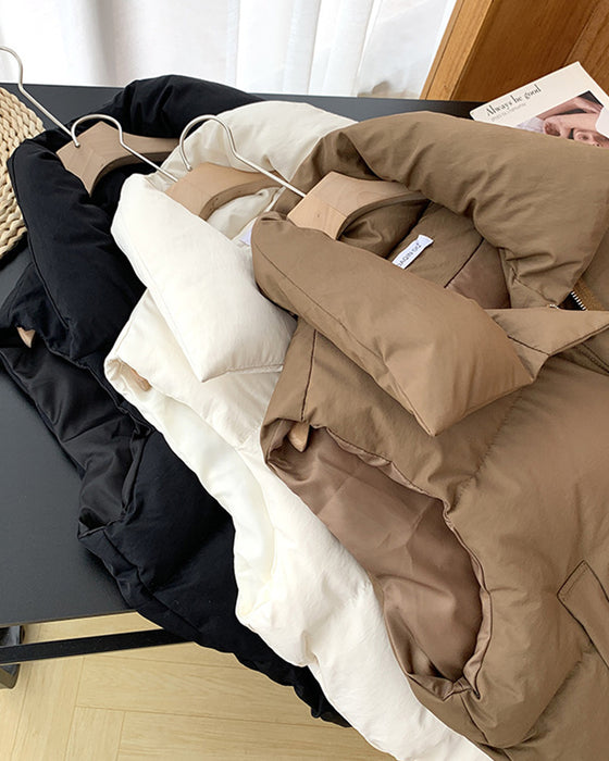 Eenvoudige effenkleurige, gewatteerde jas met ritszak en mouwloos design