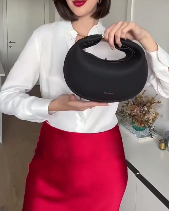 Effen kleur elegante halvemaanvormige schoudertas onder de arm