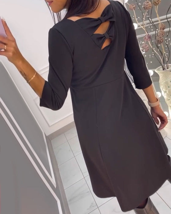 Effen jurk met strik op de rug